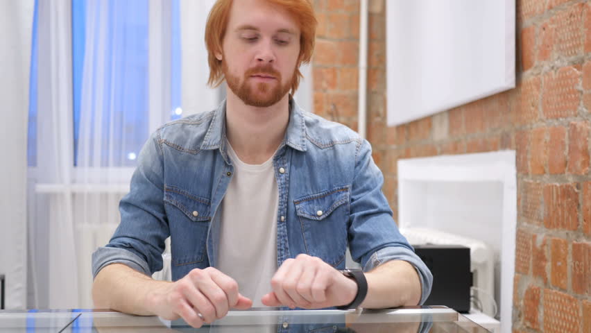Redhead Beard Man Using Smartwatch for Browsing Email and Messages