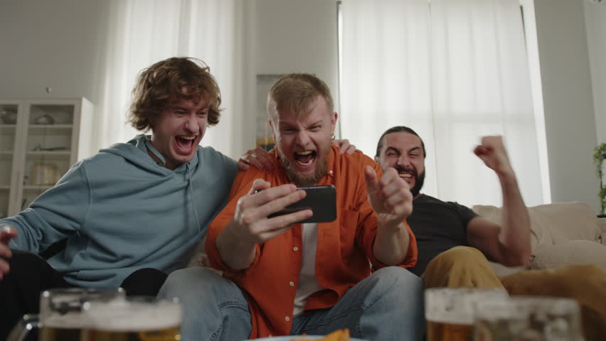 Sport fans cheering for favorite team, watching match on smartphone and talking phone. World Sport games USA, Canada, Mexico. North America Football Cup, Football, sports and soccer fans. Slow Motion