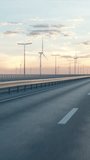 Self driving autonomous electric car driving along a bridge or coastal highway with wind turbines in background. Sustainable energy concept. Realistic high quality 3d animation. Vertical Video