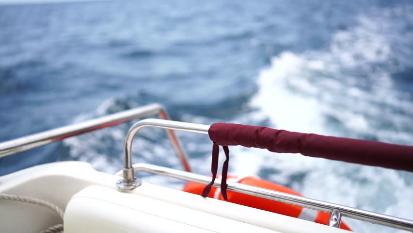 waves of a boat on the blue sea with splashes and a wake from a yacht. Travel and journey concept