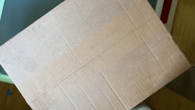 A male hand skillfully uses a cutter to carefully open a box, revealing the secret contents inside. - Powered by Shutterstock - Get 15% off with code: PIKWIZARD15