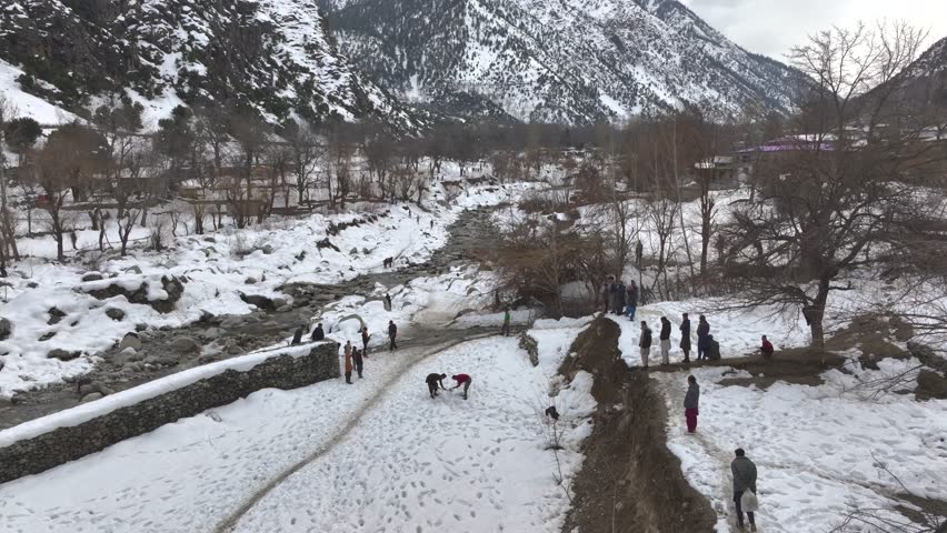 Snow Golf Traditional Game of Kalasha People, Batrik vs Brun Villages. Khyber Pakhtunkhwa, Pakistan at Winter. Aerial