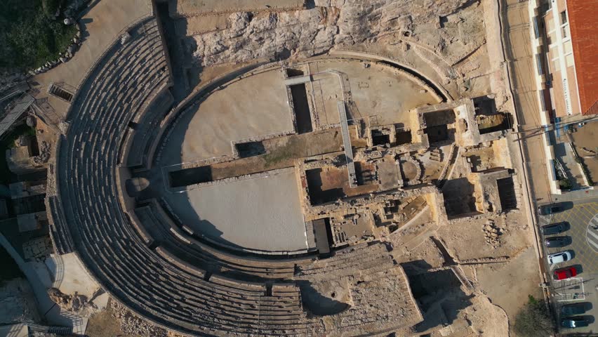 ancient Roman amphitheatre in Tarragona, Spain, old ruined coliseum, antique architecture, aerial drone view 4k