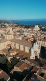 cathedral and cozy streets with ancient architecture of coastal town Tarragona, Spain, aerial drone view 4k, vertical video footage