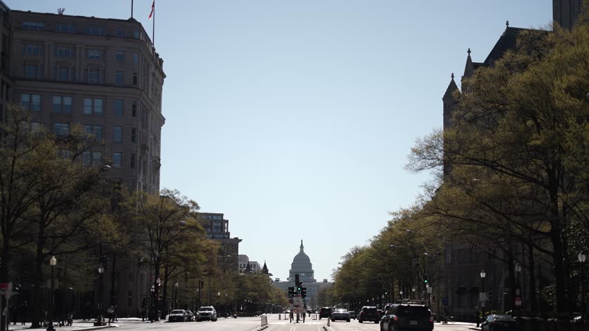 View of the US Capitol looking down Pennsylvania Avenue, NW with traffic on a spring summer morning