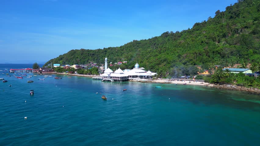 Islamic white mosque at beach on Perhentian Island. Wonderful aerial top view flight panorama overview drone
4k