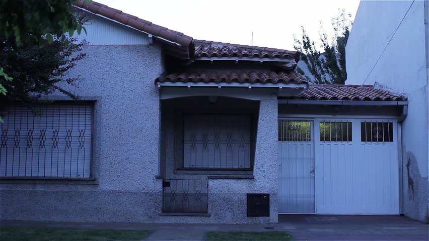 Friends Riding Bikes in front of a Residential House in Buenos Aires, Argentina. 