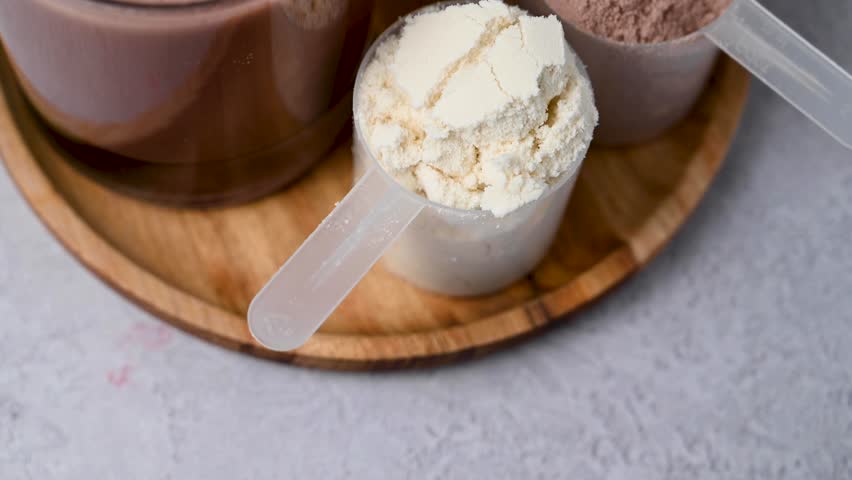 Protein powder and protein drinks, with scoops. Food supplement, bodybuilding, fitness and sport