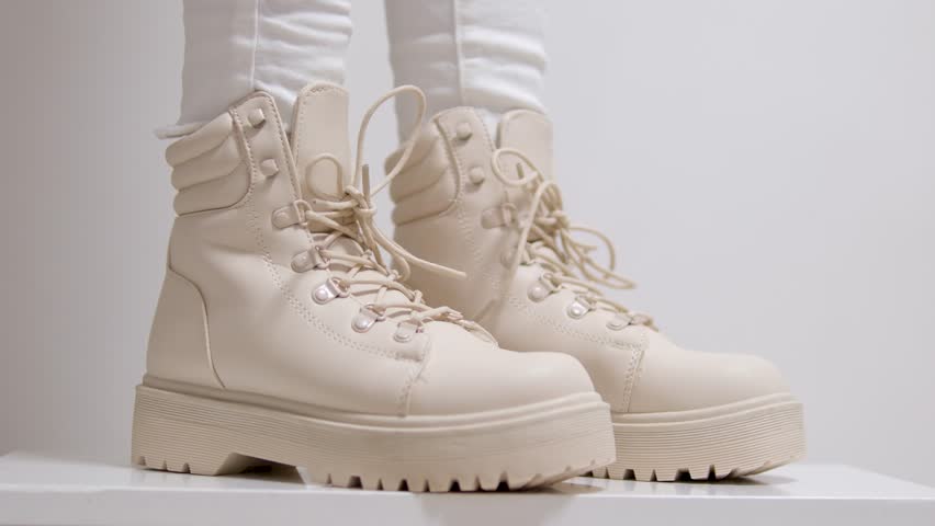 women's beige lace-up shoes with high soles on a white background classic fashion show for buying for winter autumn shoes in a milky store