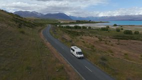 Camper Van Driving On Asphalt Road Near Lake Tekapo In South Island, New Zealand. drone shot, slow motion - Powered by Shutterstock - Get 15% off with code: PIKWIZARD15