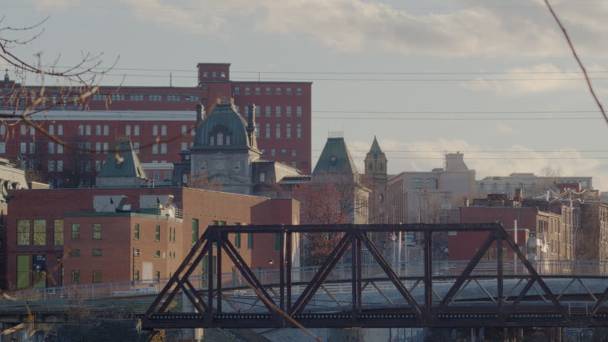 Eastern Townships small city Sherbrooke downtown with railroad bridge and buildings in Quebec Canada Estrie time lapse
