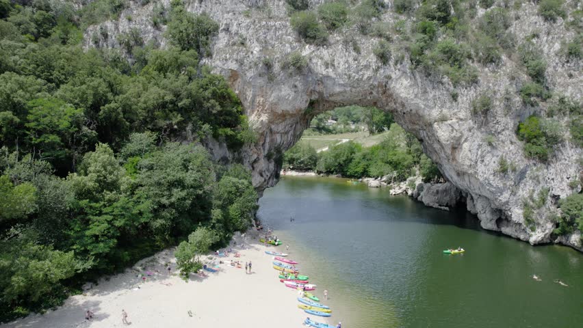 Many People And Canoe On the Sandy Beach Of the Ardeche River At Pont D
