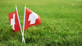 Swiss flag and soccer ball. Flag of Switzerland and football ball on the grass. - Powered by Shutterstock - Get 15% off with code: PIKWIZARD15