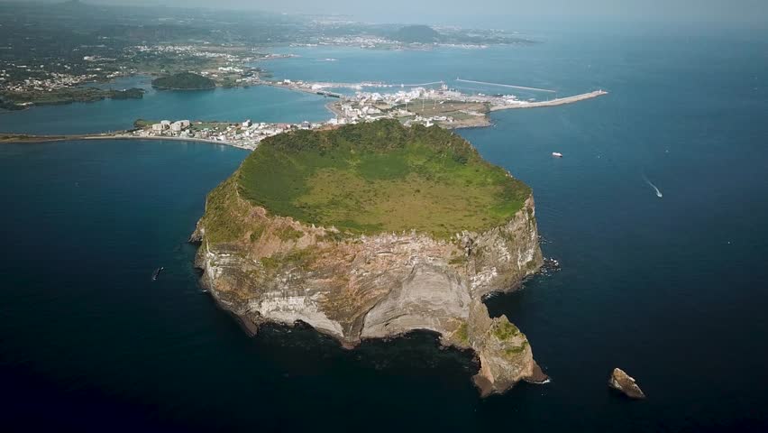 Drone shot of Seongsan Ilchulbong in Jeju Island, Republic of Korea. Aerial view of Crater peak in South Korea. High quality 4k footage
