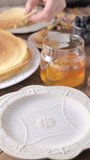 thin Russian pancakes adorned with fresh berries in this mouthwatering culinary showcase. Vertical video for social networks. cooking video. High quality footage