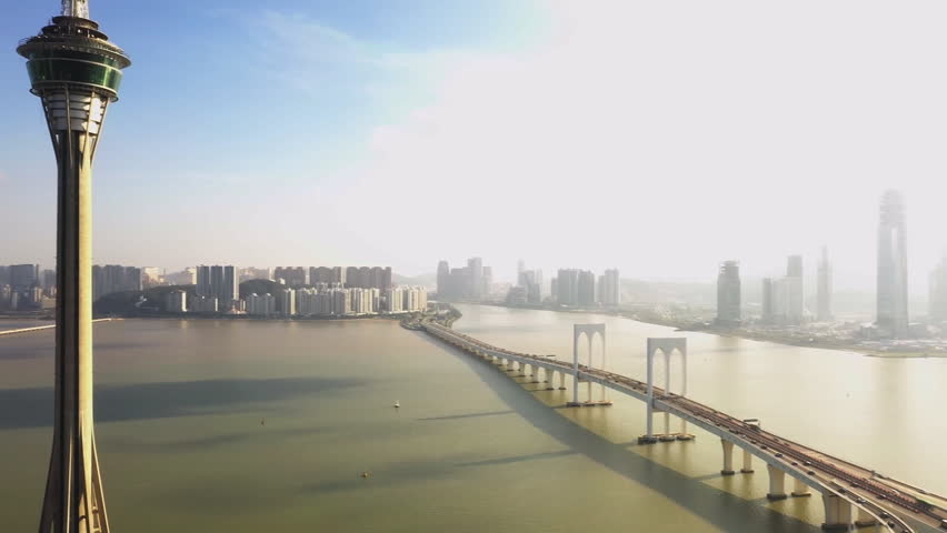 Urban landscape of Macau with famous traveling tower under blue sky near river in Macao, Asia. (aerial photography)
