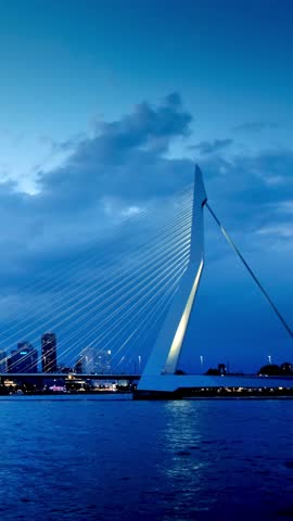 Erasmus Bridge (Erasmusbrug) and Rotterdam skyline illuminated at night. Rotterdam, Netherlands