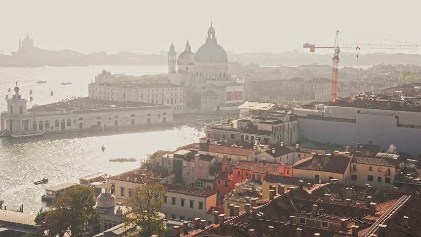 Beautiful aerial view of the sunset over Venice St. Marco square in Italy. Magical panoramic view of Venice at dusk with tourists exploring the city.