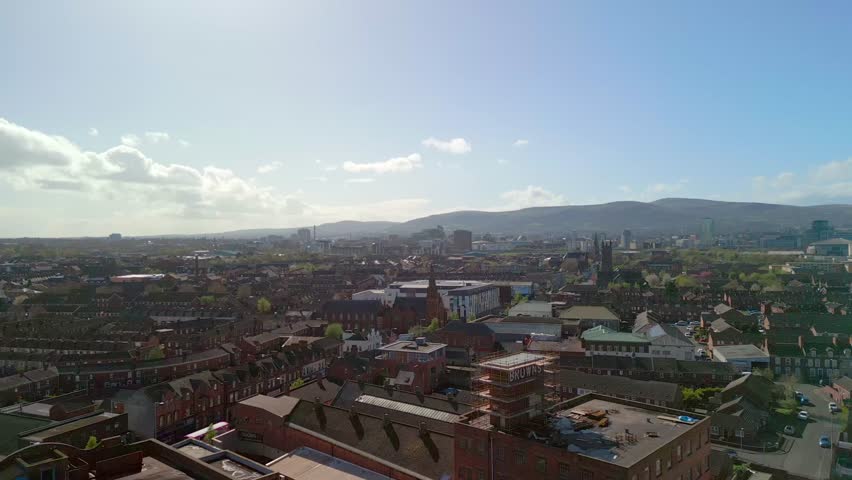 Aerial shot flying over East Belfast, Northern Ireland on a bright spring day. The camera starts wide and pushes forward. Filmed in 4K, 50 frames per second in Rec709 color space. Royalty-Free Stock Footage #3483100257