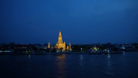 Zoom in, View of the Chao Phraya River at night  and Wat Arun Ratchawararam Ratchaworamahawihan, Bangkok, Thailand