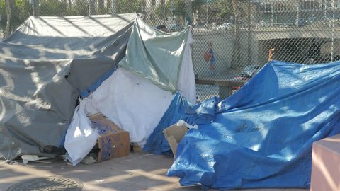 Homeless Shelters made from tarps and trash on an overpass