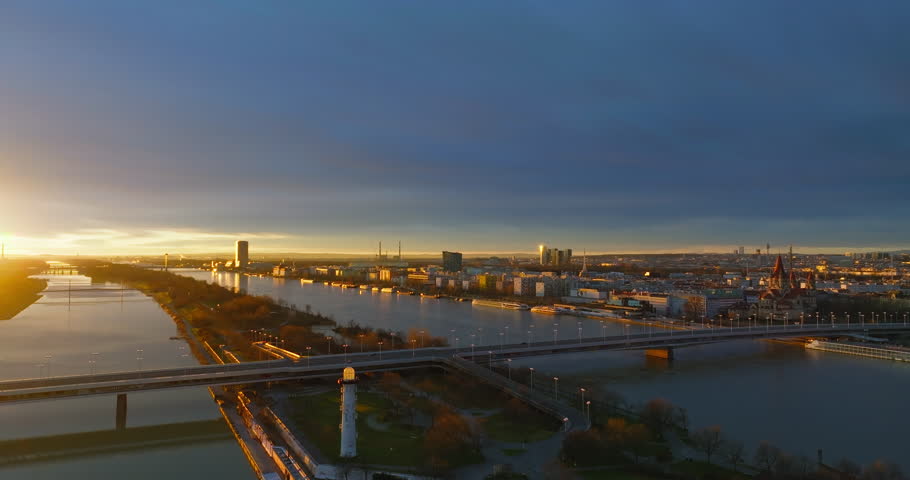 Aerial view cityscape sunset in Vienna Austria. Panoramic urban landscape of the city with the Danube river, bridges and high-rise buildings of business centers. High quality 4k footage