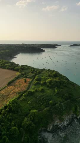 Aerial view of Cancale coastline with sandy beaches and moored boats, Ille-et-Vilaine, France.