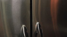 close up of woman's hand opening food storage cupboard