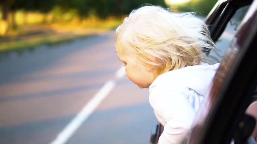 Child in car. Hair in the wind.
