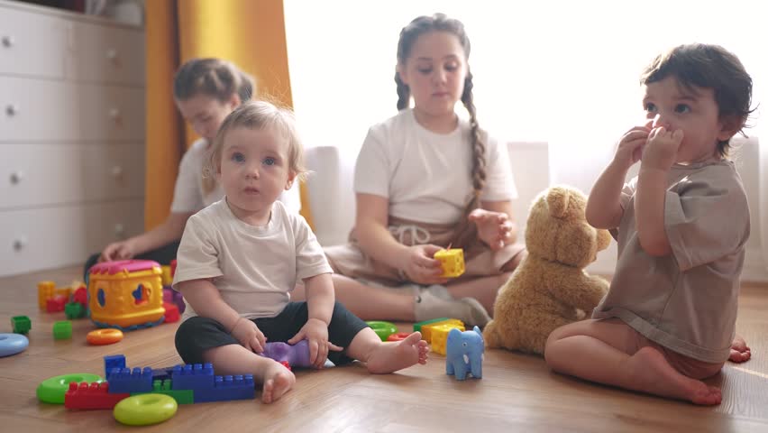 baby group children playing toys on floor indoors. happy family kindergarten kid dream concept. group children playing in kindergarten lifestyle indoors toddlers and babies and kids into toys Royalty-Free Stock Footage #3483306119