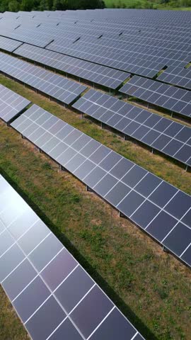 drone view of a solar power station next to a forest during summer. Renewable energy meets nature in action