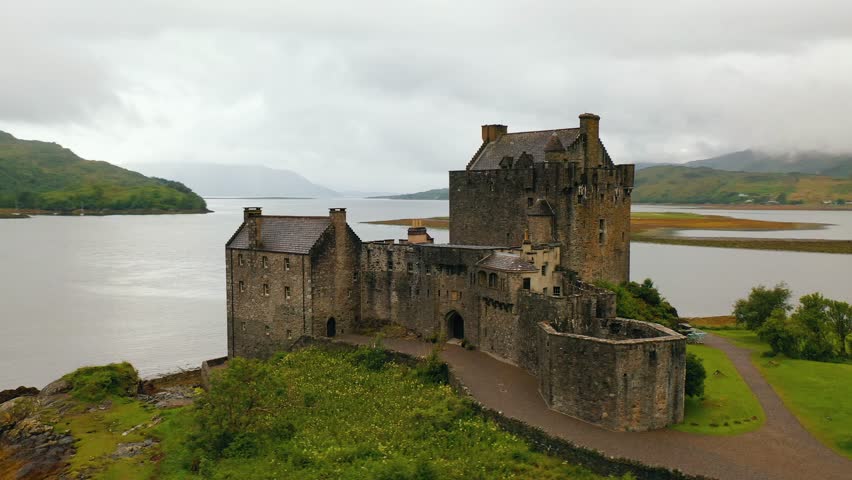 Close up aerial pan around Eilean Donan castle, national landmark and 13th century building in the Scottish highlands, Scotland