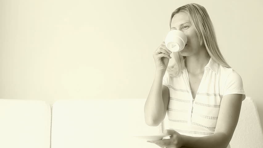 girl in a hotel room drinking coffee 