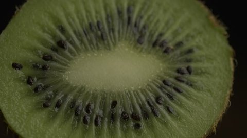 Kiwi fruit slice in extreme close up stock footage. 