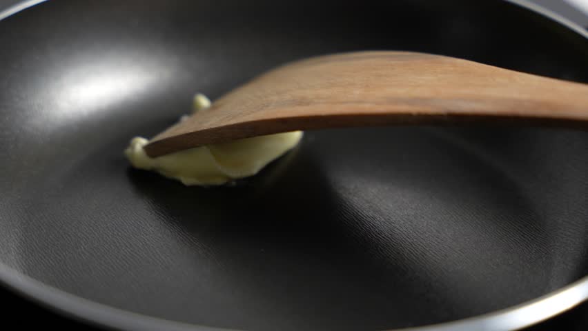 Butter melts in a hot frying pan. Butter in a frying pan.