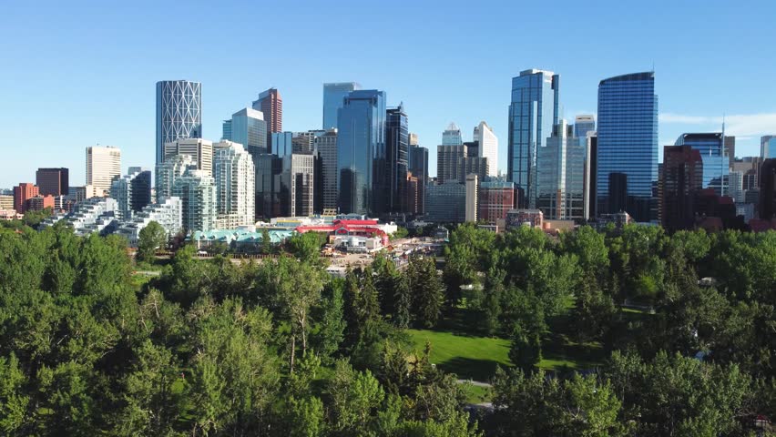 Downtown Calgary, Alberta, Canada skyline. Prince Island Park. Wide aerial drone view, from the North on a clear sunny blue sky day.