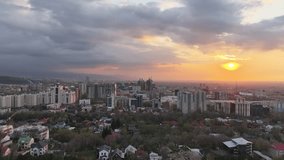 View from a quadcopter of the largest city of Kazakhstan, Almaty, on a spring evening at sunset