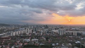 View from a quadcopter of the largest city of Kazakhstan, Almaty, on a spring evening at sunset