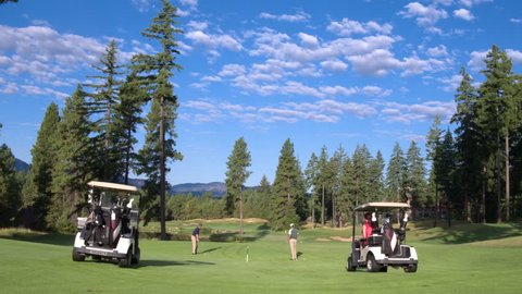 Three people playing golf on Suncadia Resort
