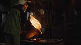 Team of foundry workers pouring glowing molten iron from ladle into molds - Powered by Shutterstock - Get 15% off with code: PIKWIZARD15