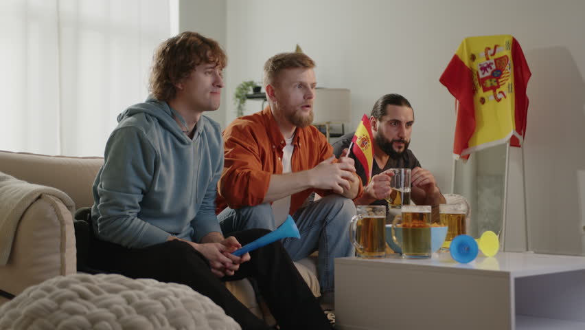 Spanish fan watching match on tv and drinking beer while rejoicing celebrating goal.European Germany and World football cup, Germany 2024, 2026 USA, Canada, Mexico. Football, sports and soccer fans. 