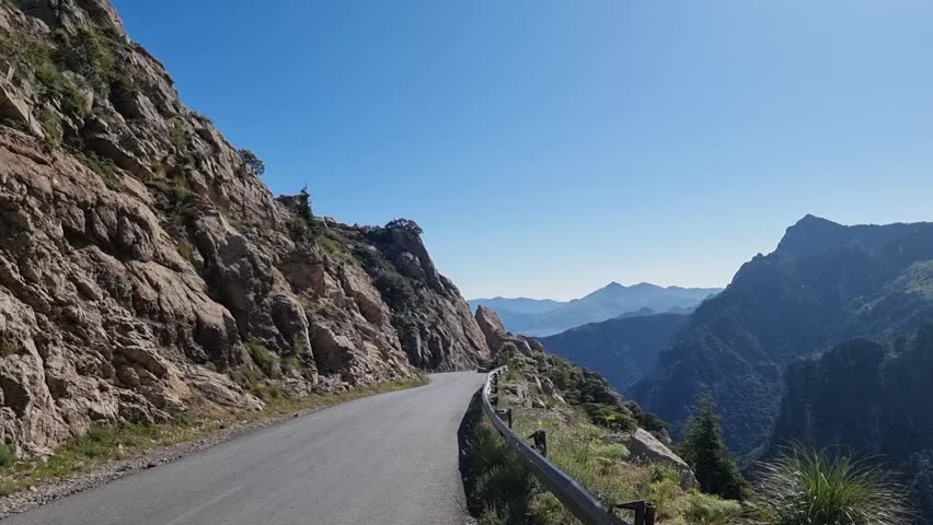 Experience the thrill of adventure as you navigate through the serene beauty of the Algerian mountains, with cascading clouds adding a touch of mystery to the landscape