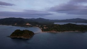 4K Aerial Drone video of a mesmerizing sunset at Las Cabanas beach in El Nido, Palawan, Philippines