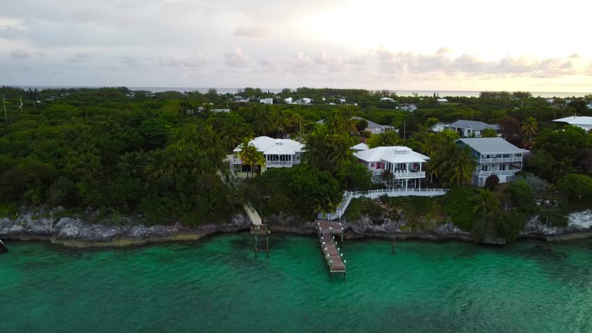 Summer vacation in the Bahamas. Flying my drone over the coast of Spanish Wells, Bahamas. Plenty of beautiful homes with piers and docks on the coast. Theres an abandoned shipwreck on the coastline. 
