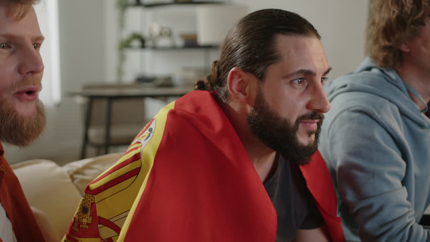 Males spanish fans watching football match on tv , cheering for Spain team. European Germany and World football cup, Germany 2024, 2026 USA, Canada, Mexico. Sports and soccer fans. Slow Motion