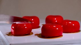 the process of making delicious mousse cakes with red icing a female hand few videos for the clip filling on a plate brownie inside