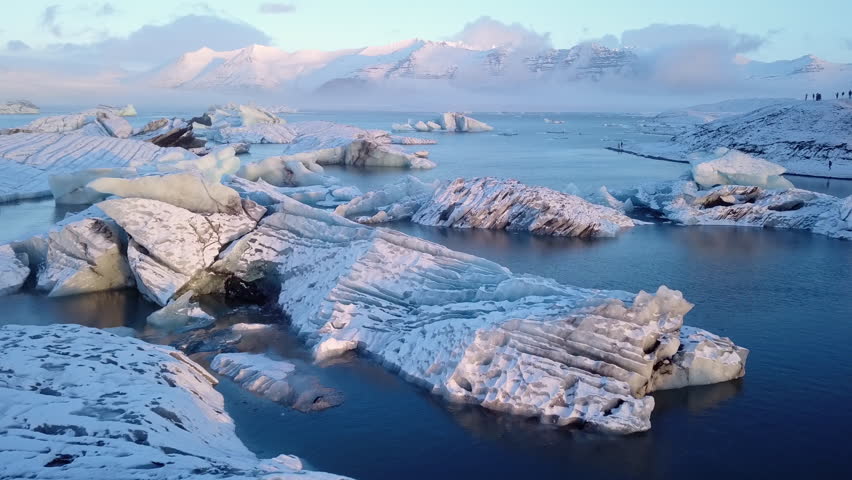 Aerial drone view flying pass over icebergs in Jokulsarlon glacier lagoon, Iceland