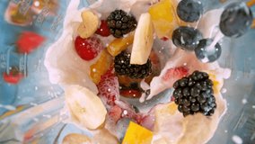 Super Slow Motion of Mixing Fruit Pieces with Milk in Blender. Camera Moving up Focusing Crushing Fruit. Filmed on High Speed Cinema Camera, 1000 fps. - Powered by Shutterstock - Get 15% off with code: PIKWIZARD15