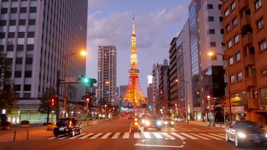 street view of business area with view of Tokyo Tower in sunset to night time with some traffic on road,Tokyo Tower landmark famous tourist attraction in 4K UHD video in japan Royalty-Free Stock Footage #3483758583