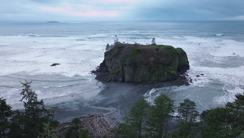Washington State, aerial of cinematic Olympic National Park. Dramatic sea stacks on rocky Ruby Beach along the Olympic coastline on moody overcast evening. Ruby Beach on West Coast of Northern America